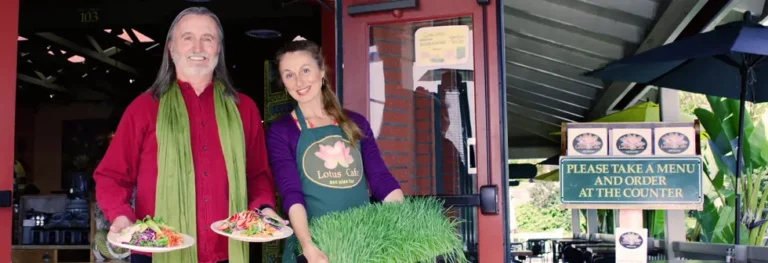 Lotus Cafe owners serving fresh vegetarian dishes outside the cafe.