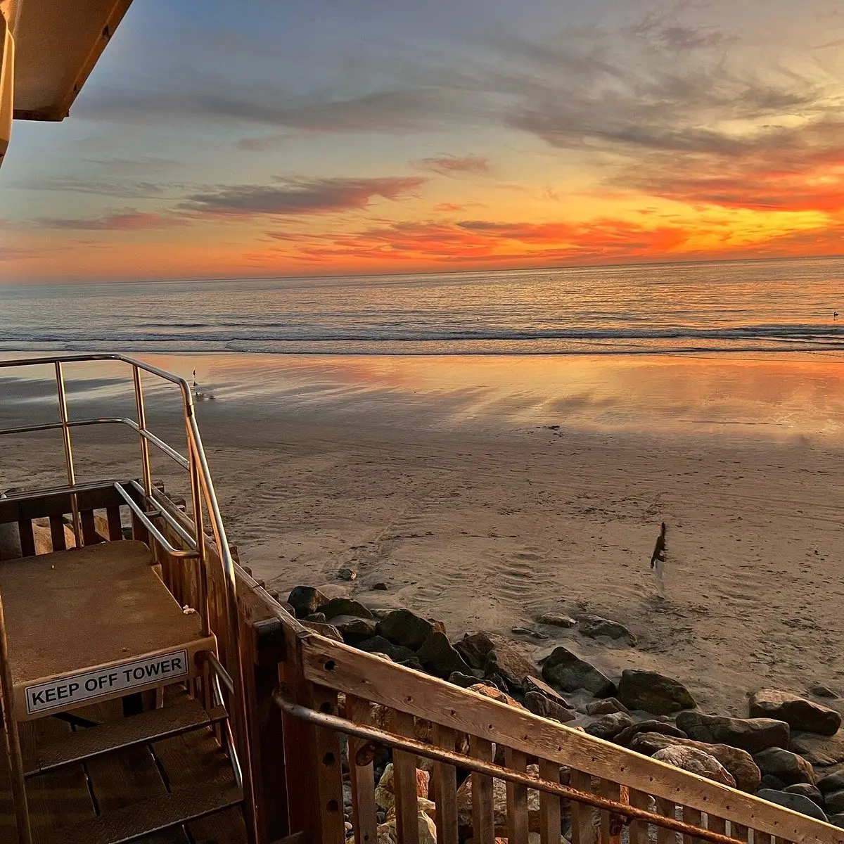 Sunset view from a balcony overlooking the beach.