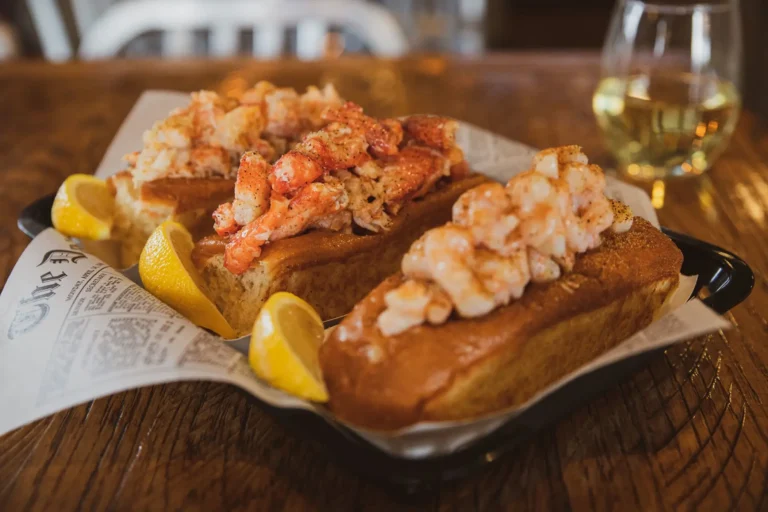 Platter of lobster rolls garnished with lemon.